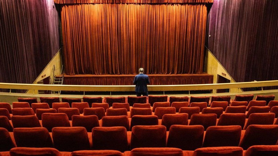 Man standing in empty cinema in Morocco