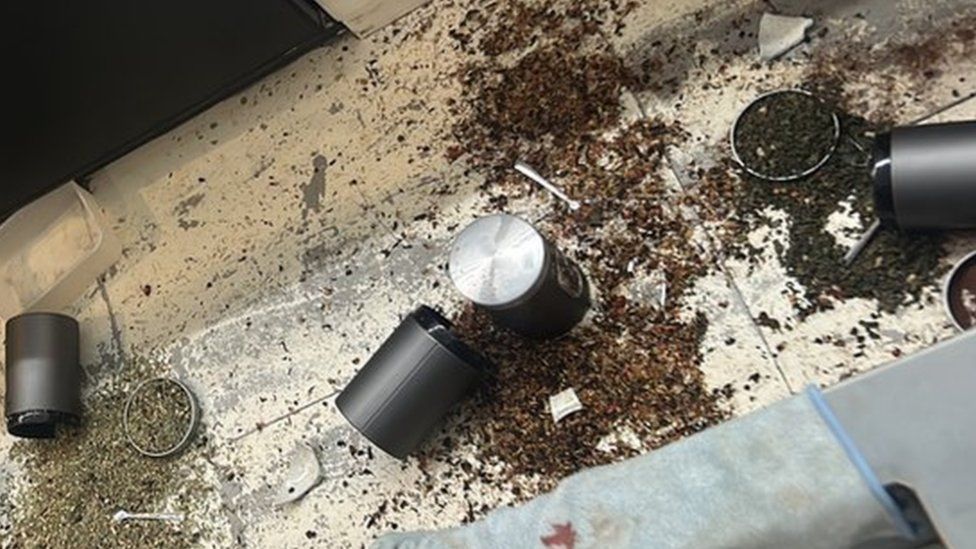 Image showing three opened canisters of food which is strewn across the floor