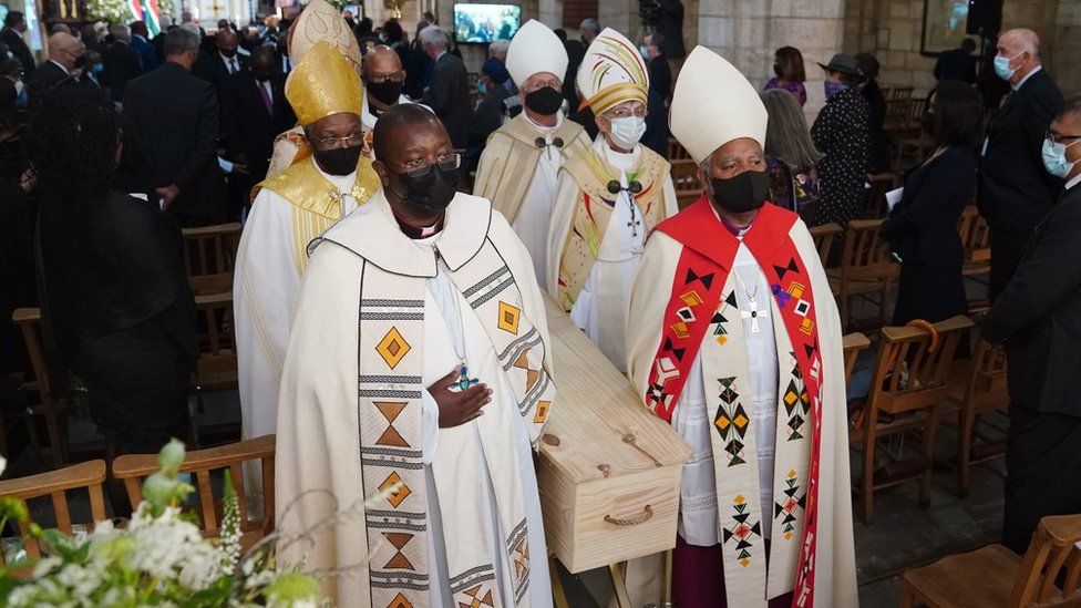 Members of the clergy carry the coffin of the late Archbishop Emeritus Desmond Tutu as they exit the St. George"s Cathedral during his state funeral in Cape Town, South Africa, 01 January 2022.