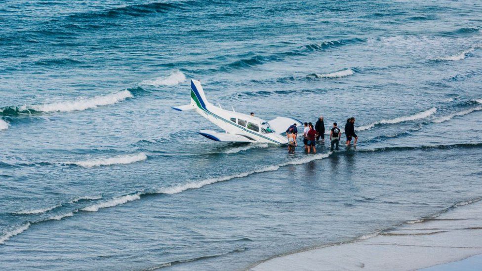 The plane landed in the sea on the edge of the beach