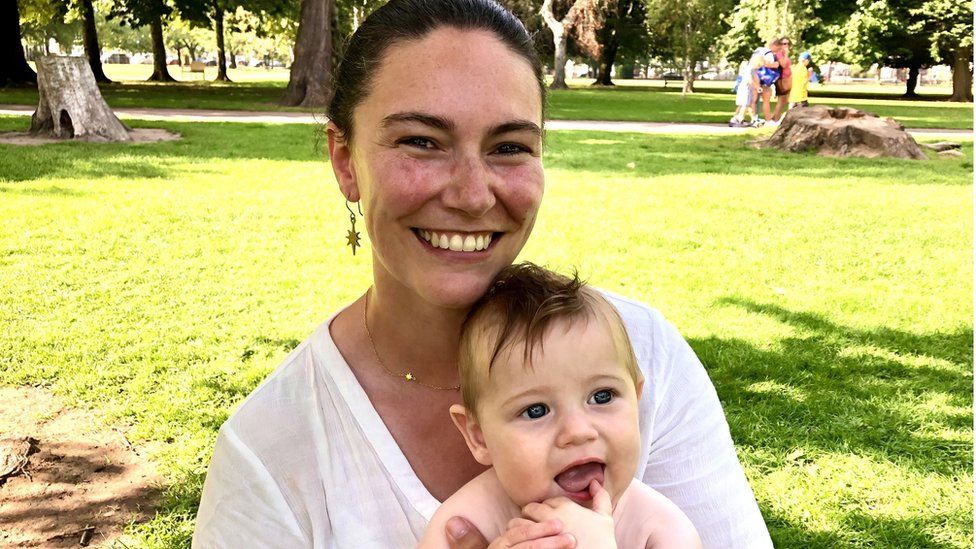 Rowan Davies with five-month-old Mabon in a park