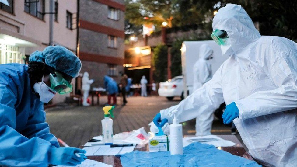 Doctors prepare to administer the mandatory COVID-19 coronavirus test for detainees of a Government designated quarantine facility in Nairobi on March 29, 2020