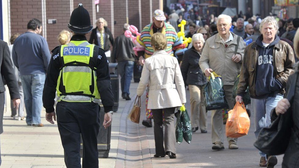 A police officer walking down the street