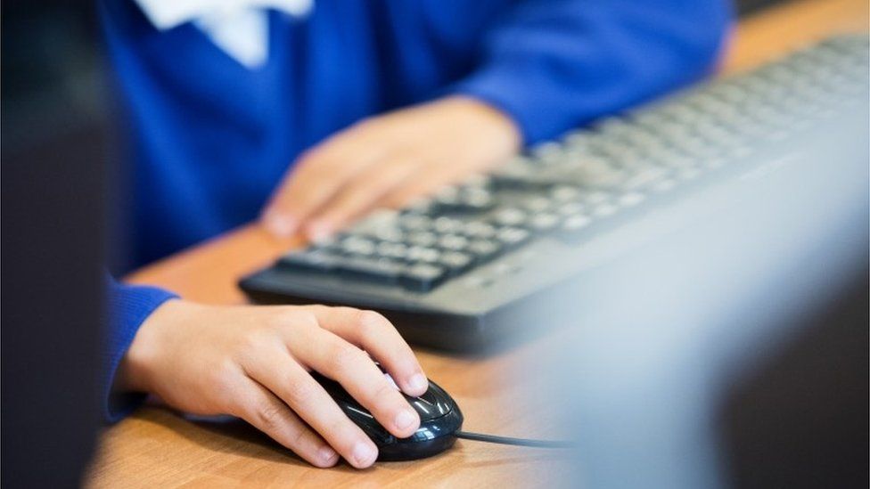 Boy's hand on a computer mouse