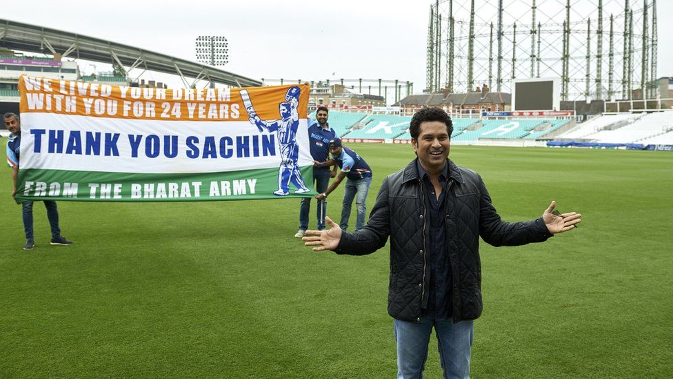 Indian cricket legend Sachin Teldulkar (R) poses for a photograph with members of the Bharat Army (Indian cricket fans), during a photocall at the Oval cricket ground in south London on May 6, 2017, promoting the upcoming release of his film, 'Sachin: A Billion Dreams'.