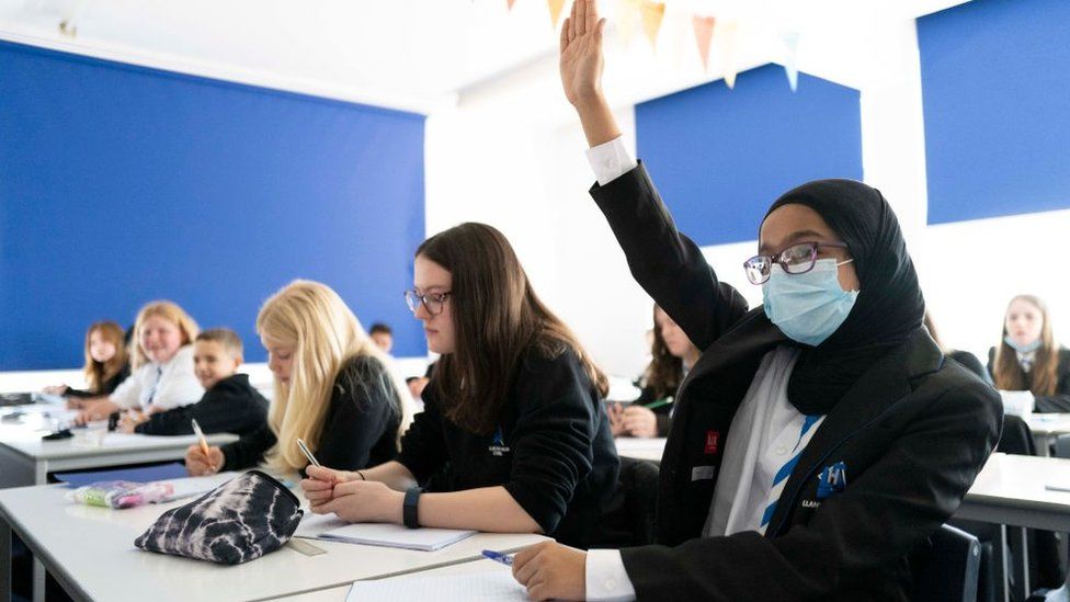 A child raises their hand during a maths lesson at Llanishen High School on September 20, 2021 in Cardiff, Wales.