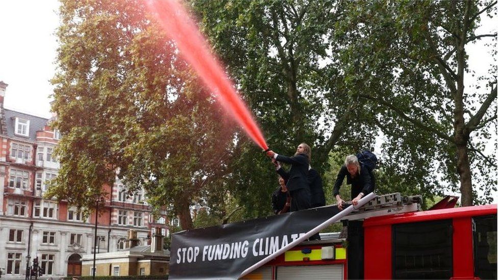 Extinction Rebellion protesters spray red water at the Treasury
