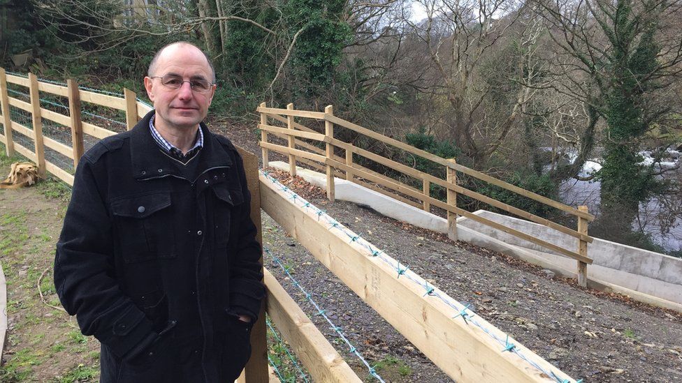 Cllr Dafydd Meurig with the new £1m Talybont flood defences
