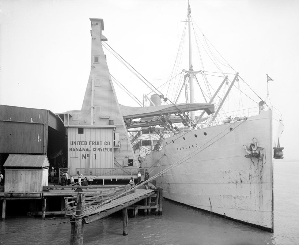 A cargo ship at the dock of the United Fruit Company banana conveyors in New Orleans, Louisiana circa 1910