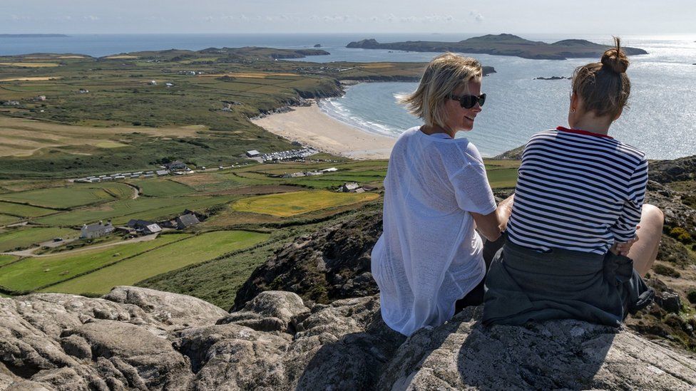 Two women enjoy the view over Whitesands Bay, St Davids, Pembrokeshire