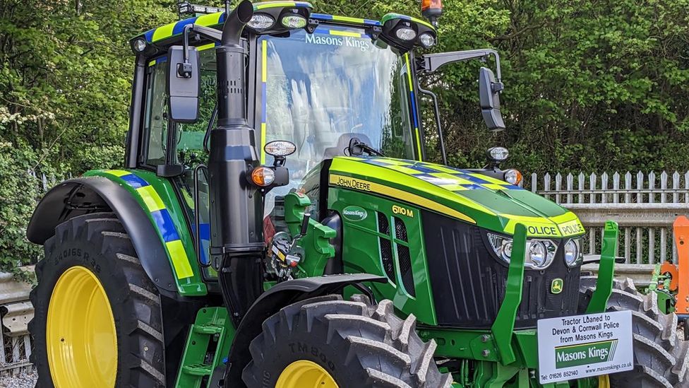 A green and yellow tractor with police livery