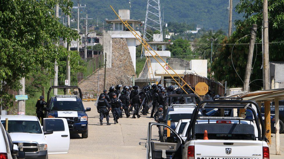 Riot police enter a prison after a riot broke out at the maximum security wing in Acapulco, Mexico