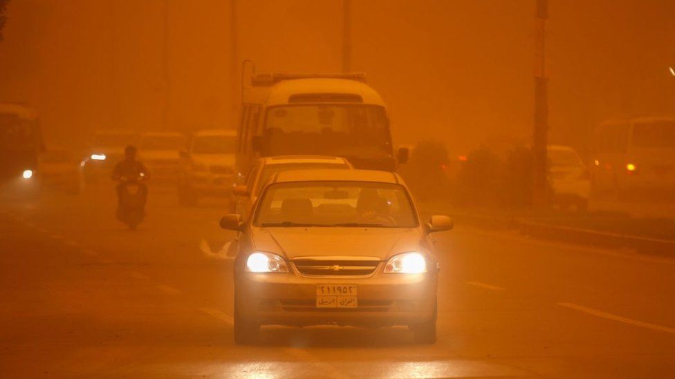 Vehicles drive along a road during a severe dust storm in Iraq's capital Baghdad