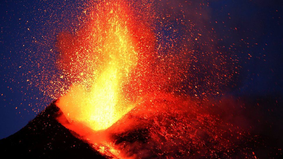 Lava exploding upwards from an erupting volcano