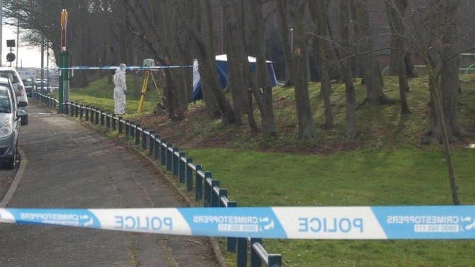 Forensic officer next to tent