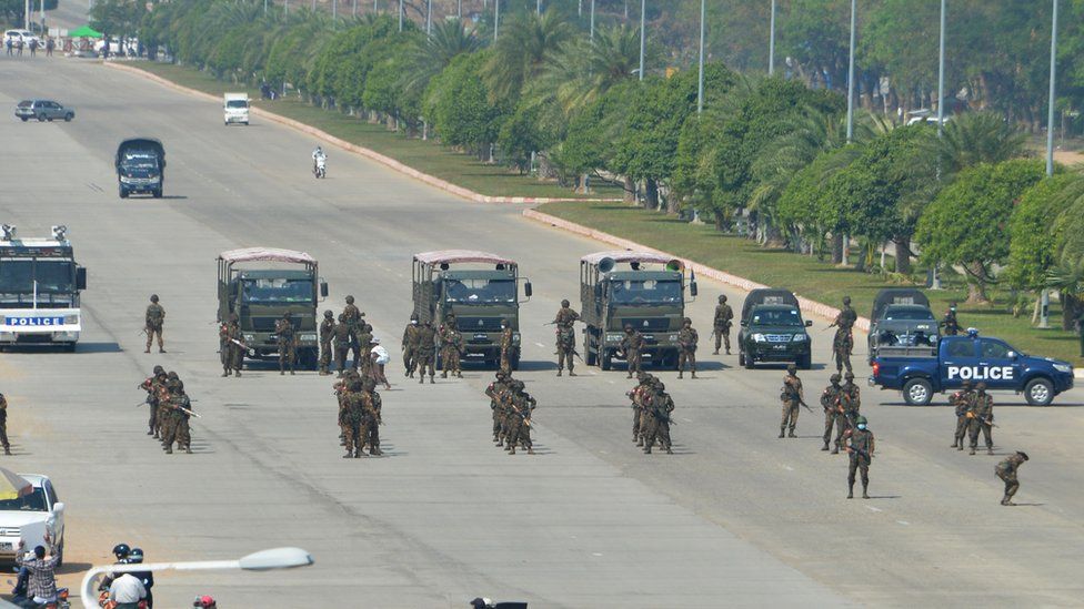 Soldiers arrive to disperse protesters taking part in a demonstration against the military coup