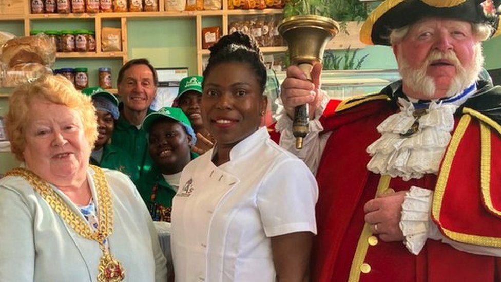 Image of the mock mayor, mayor, Maggie and the town crier at the opening of Ma's African Kitchen