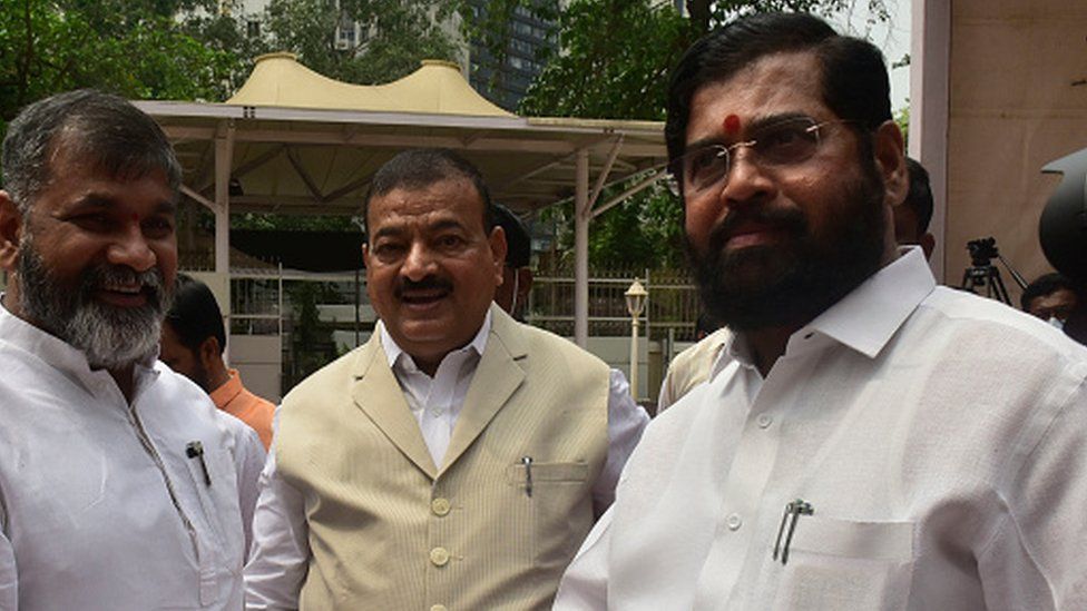Eknath Shinde (R) seen with other state lawmakers