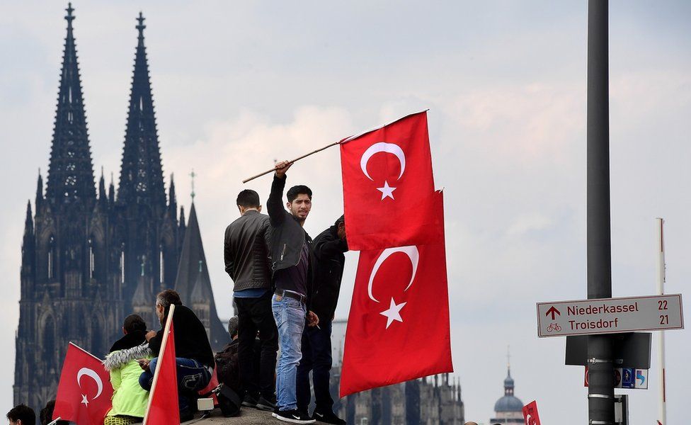 Supporters of Turkish President Recep Tayyip Erdogan rally at a gathering on July 31, 2016 in Cologne, Germany