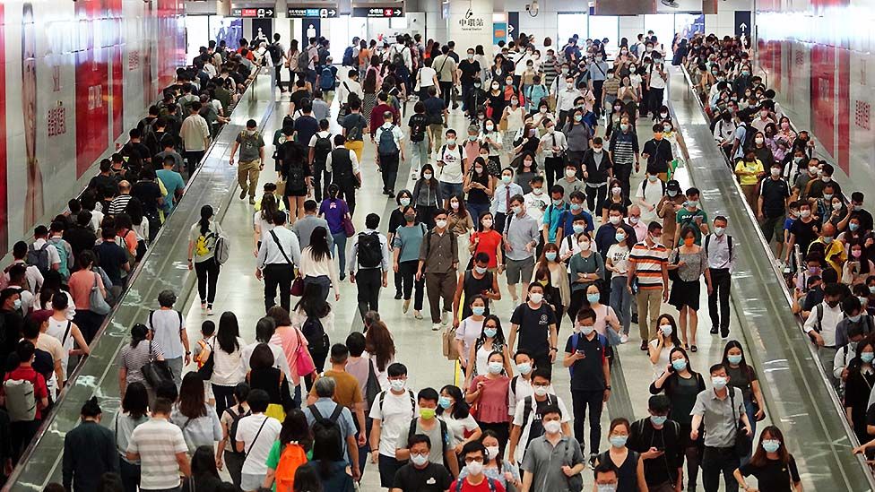 Hundreds of workers use Hong Kong's underground metro to travel to work