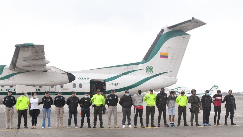 Police showing off the detained suspects earlier this month