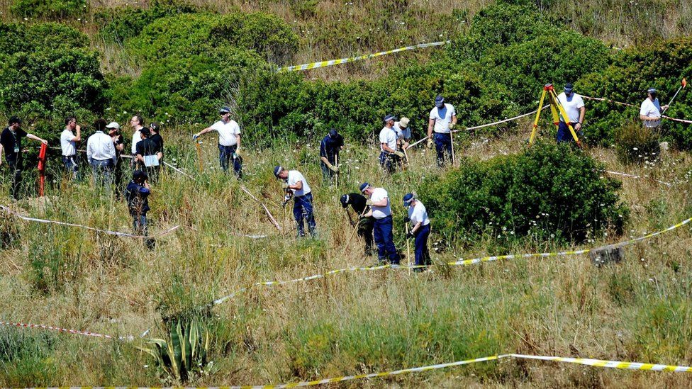 Police searching in long grass and bushes