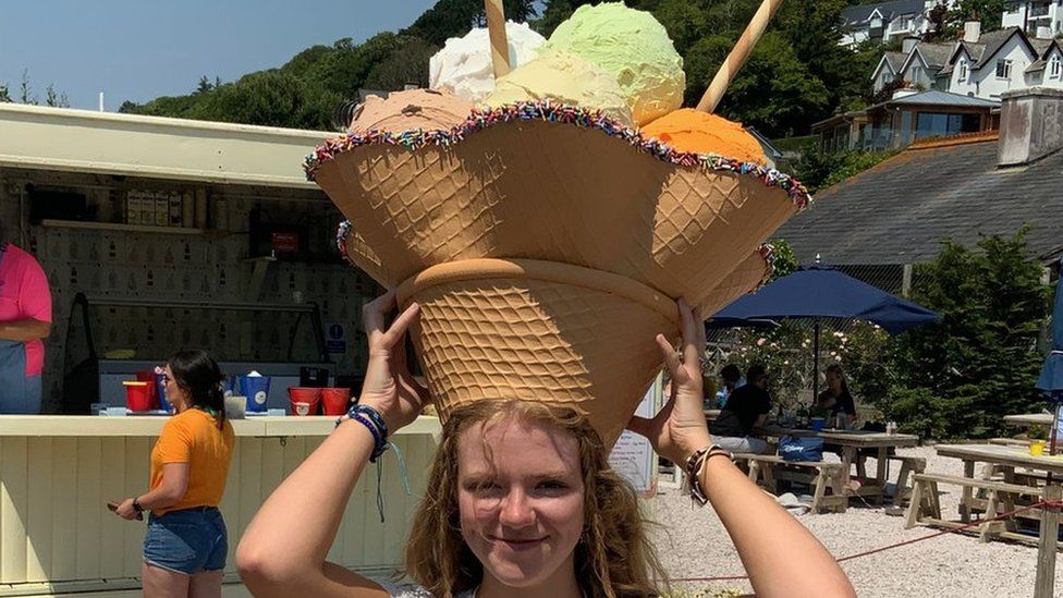 A woman wearing a hat called Sundae Best
