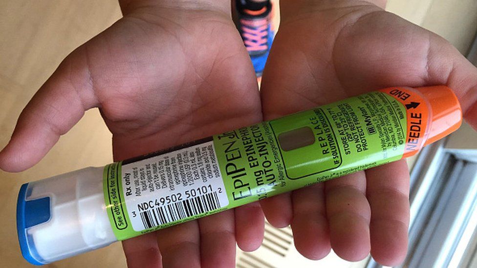 Child's hands holding EpiPen