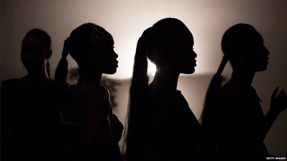 Models wait backstage during the Kinshasa fashion week in Kinshasa on July 24, 2015