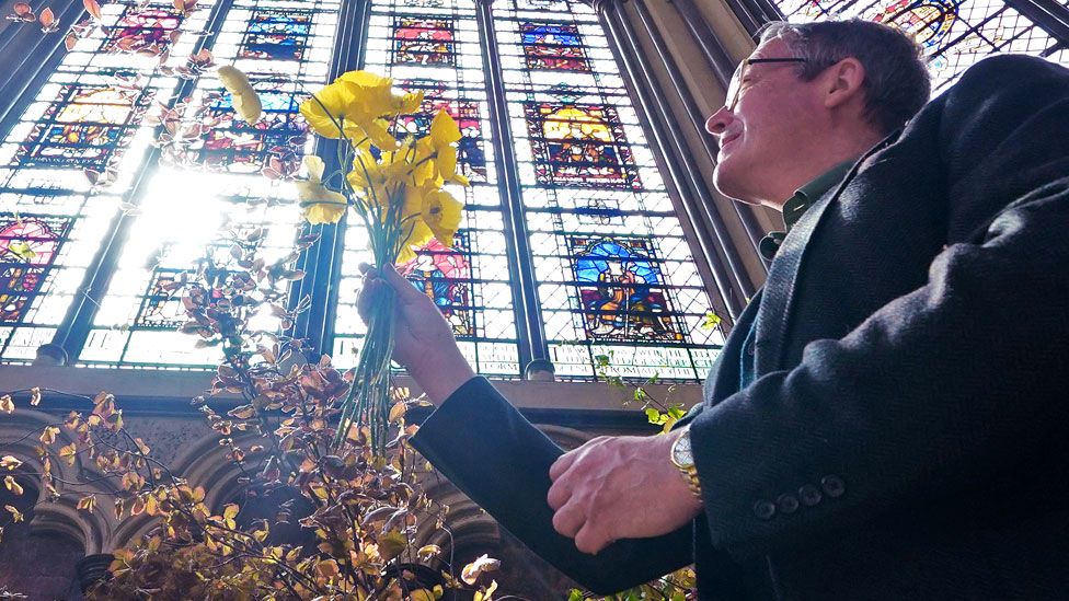 Florist Shane Connolly holding a bunch of poppies amongst the coronation service flowers, at Chapter House, Westminster Abbey on 4 May 2023 in London, England