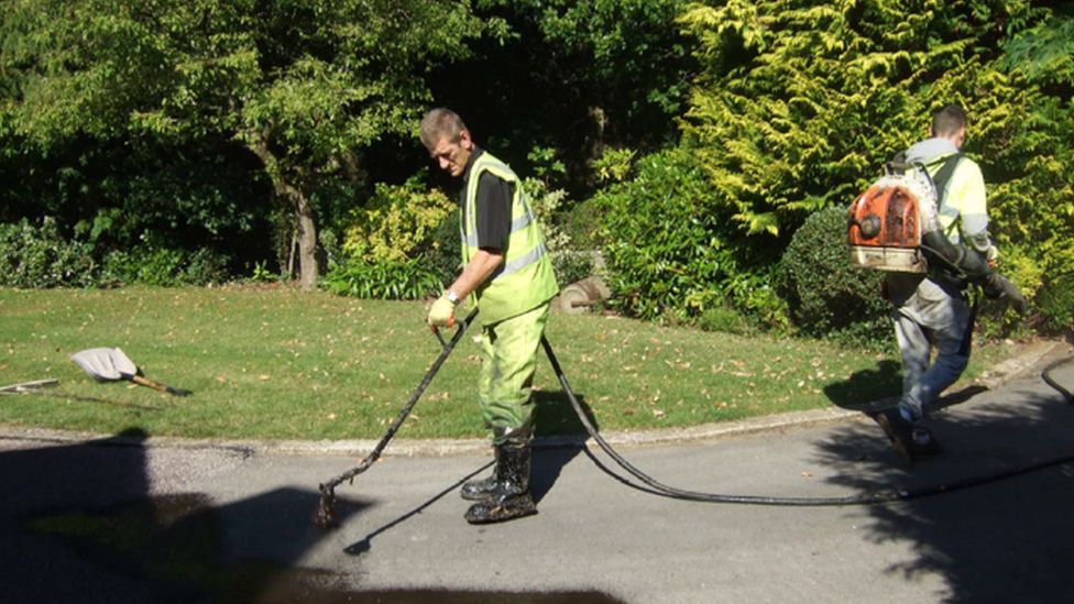 Allan John Coutts with a colleague laying tarmac