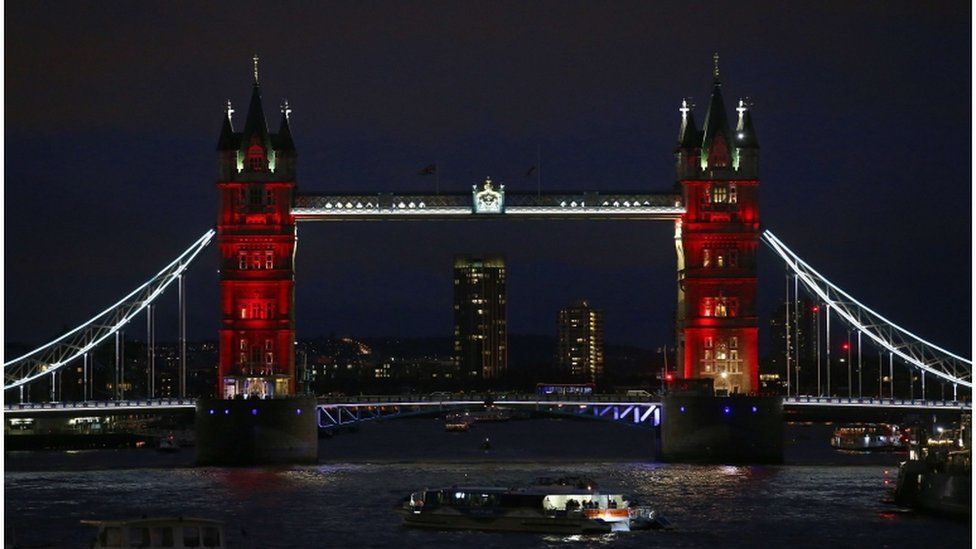 London's Tower Bridge is illuminated in blue, white and red lights