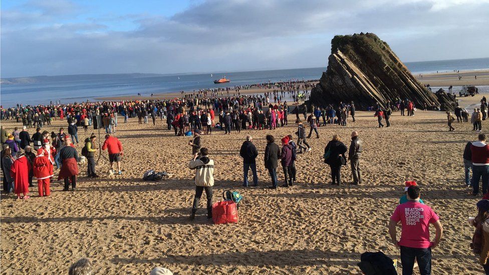 Crowds gather on Tenby's North Beach for the Boxing Day swim