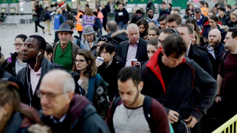 Passengers at London Victoria queue for an express train to Gatwick Airport