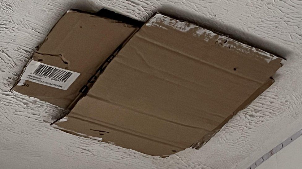 Cardboard covering up a hole in ceiling