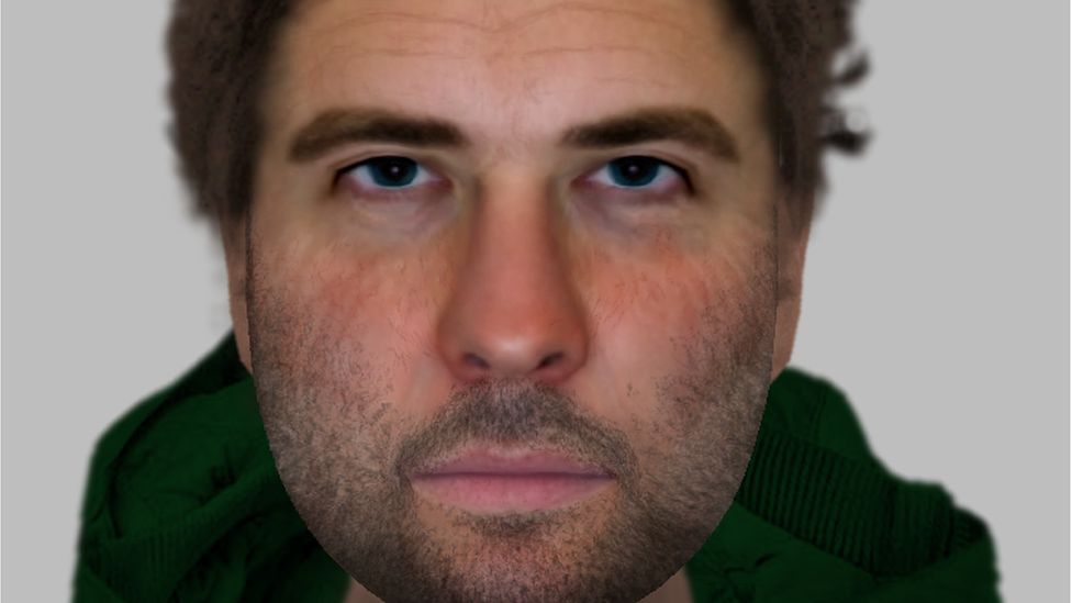 An E-fit image of a man with blue eyes, dark hair and facial hair wearing a green hoodie