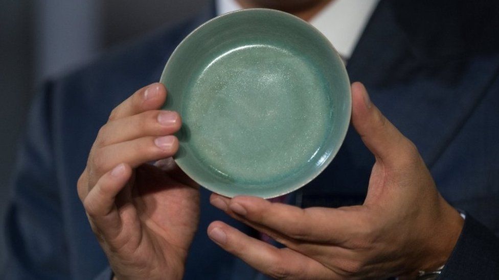 Nicolas Chow, Deputy Chairman of Sotheby's Asia International, holds a Ru Guanyao Brush Washer from the Northern Song Dynasty in Hong Kong on 3 October 2017.