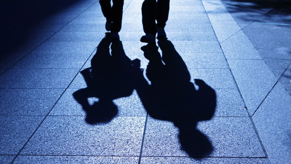 Two shadows on a street