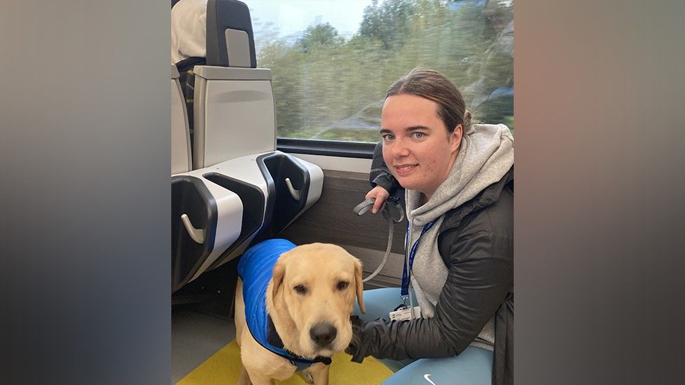 Olivia Chadwick on the train with her dog Mowgli