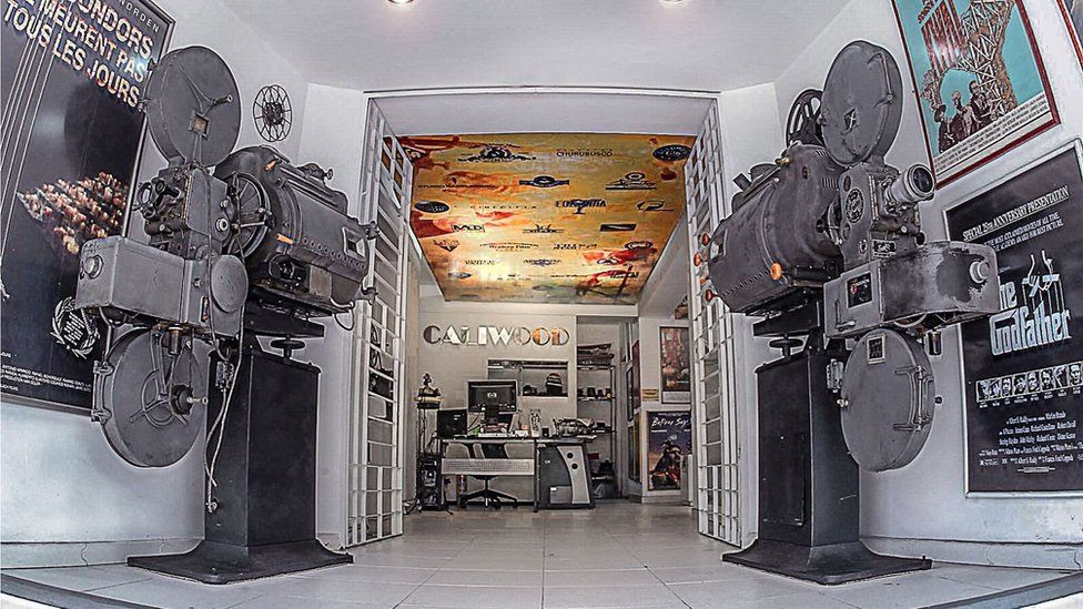 The entrance to the Caliwood Museum is flanked by two 1930s film projectors, which were left at Mr Suarez's garage