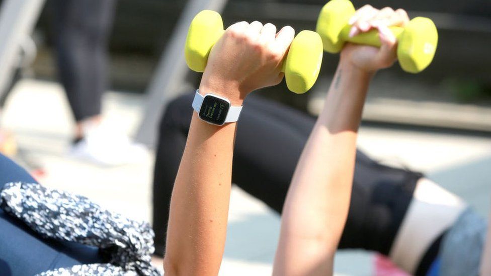 Woman exercising wearing a Fitbit