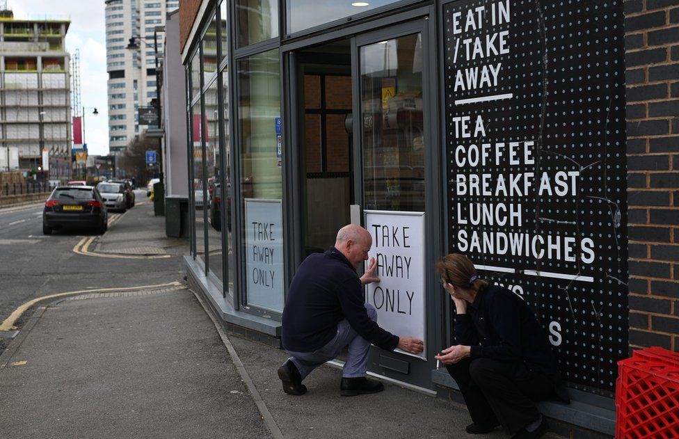 A sign saying "Take Away Only" is attached to the window of a cafe in Leeds, northern England on March 21, 2020, a day after the British government said it would help cover the wages of people hit by the coronavirus outbreak as it tightened restrictions to curb the spread of the disease.