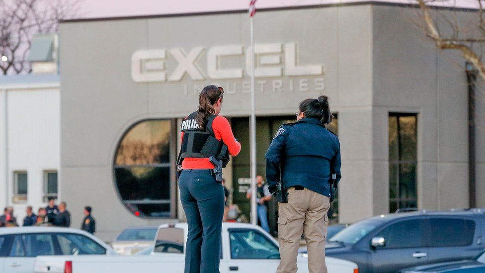 Police guard the front door of Excel Industries in Hesston, Kan., Thursday, Feb. 25, 2016