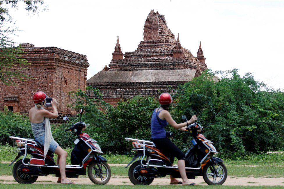 Tourists take pictures of a damaged pagoda after an earthquake in Bagan, Myanmar, 25 August 2016