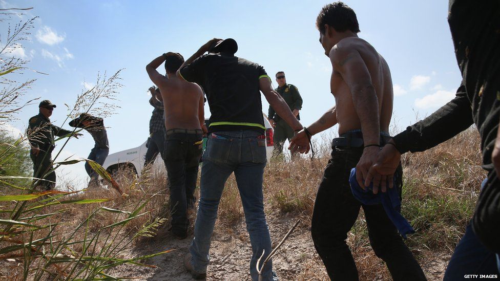 Undocumented Mexican immigrants are detained on the border by US officials.