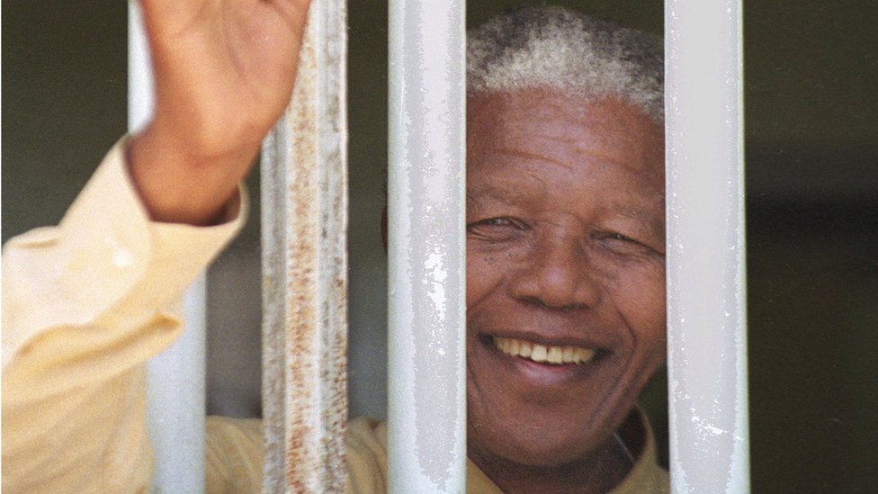 Nelson Mandela revisits the cell at Robben Island prison in 1994
