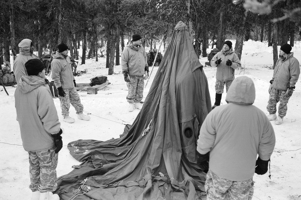 Staff Sergeant Ben Kueter instructs recruits how to erect a ten man tent