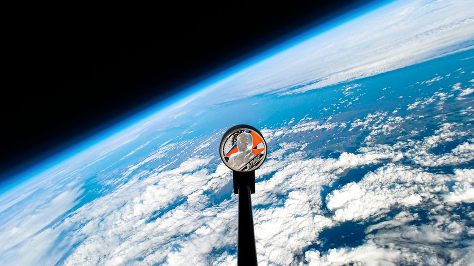 The Bowie coin in space with earth in the background