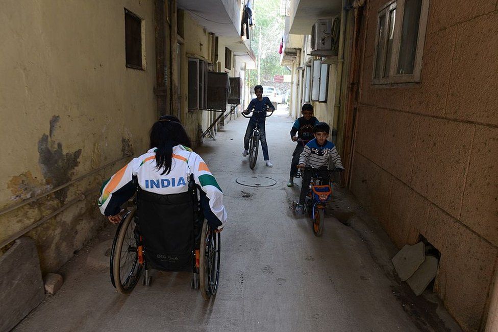 Disabled Indian sportswoman Deepa Malik leaves her home in New Delhi on March 5, 2014, for a athletics practice session.