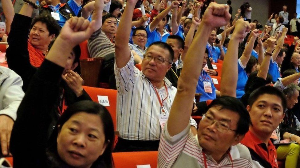 Members of Taiwan's ruling Kuomintang (KMT) raise fists during the party congress in Taipei on October 17, 2015